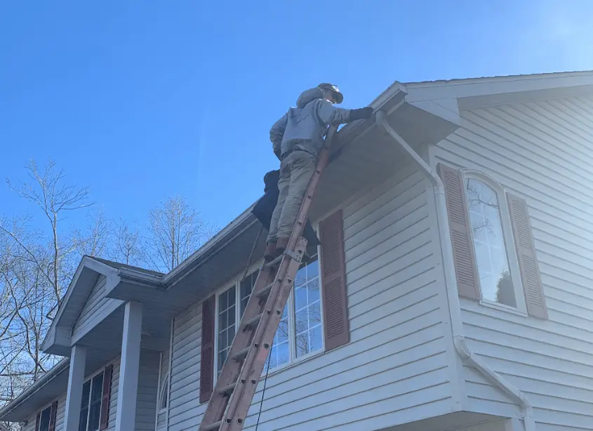 Gutter cleaning and maintenance being performed by Bay Village Power Washing in Bay Village